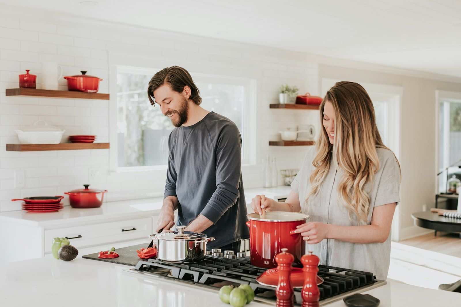 Two people cooking together in a bright kitchen